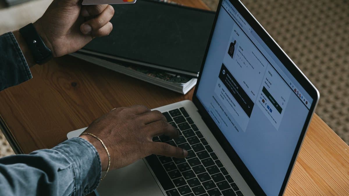 Person using a laptop to review subscription options online