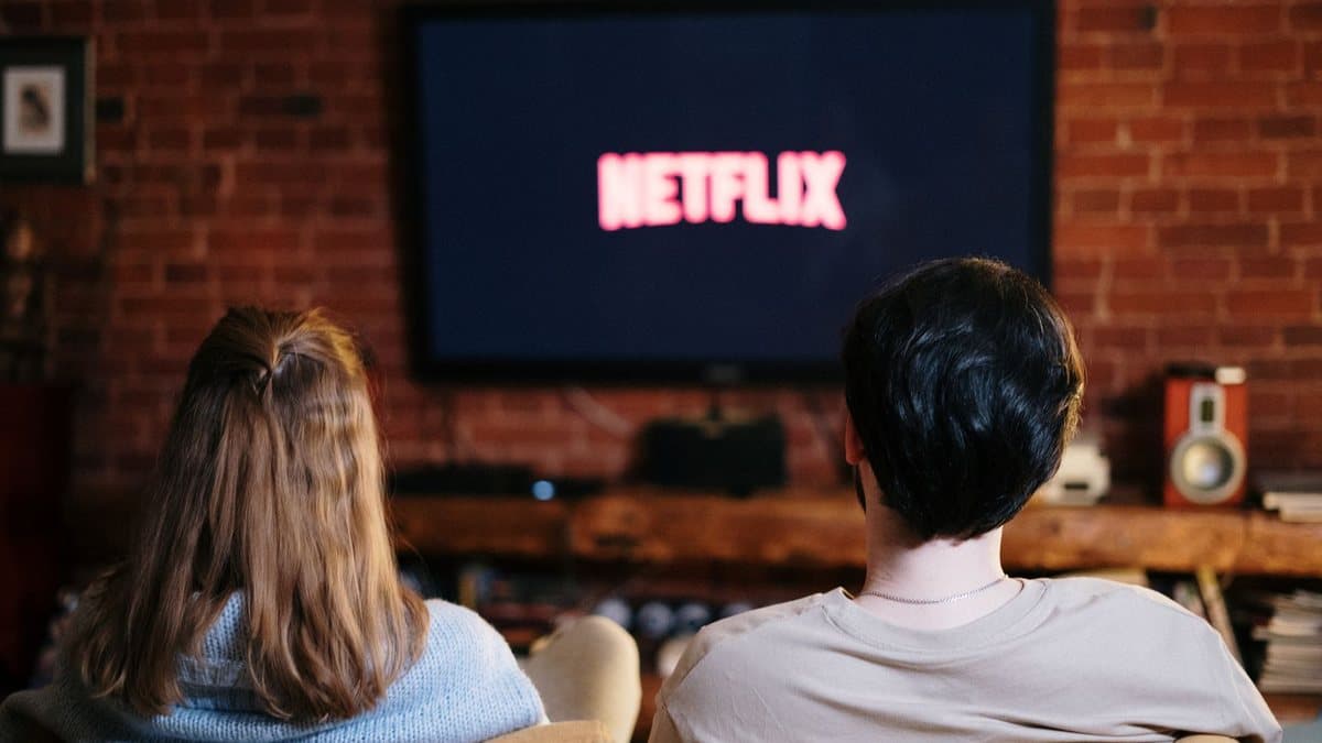 People sitting on a couch watching an on-demand streaming service