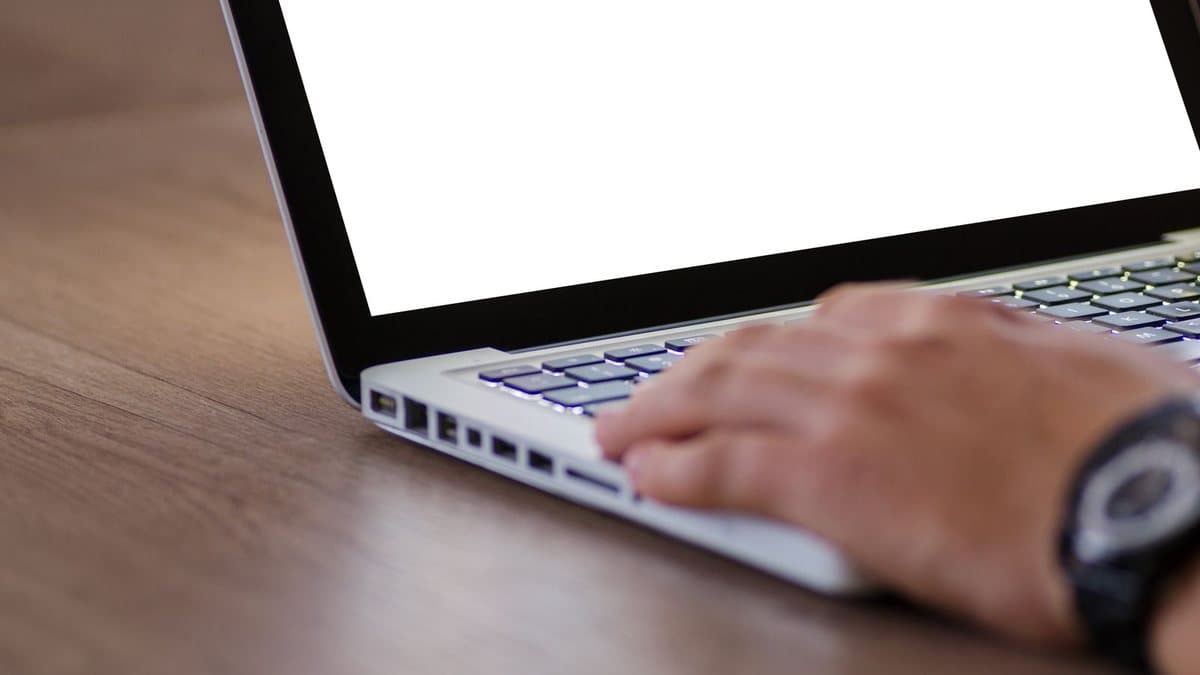 Person typing on a laptop, representing the initial account setup process