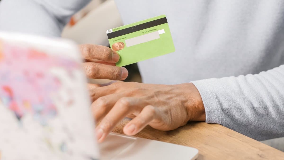 Close-up of a person holding a payment card, representing subscription billing