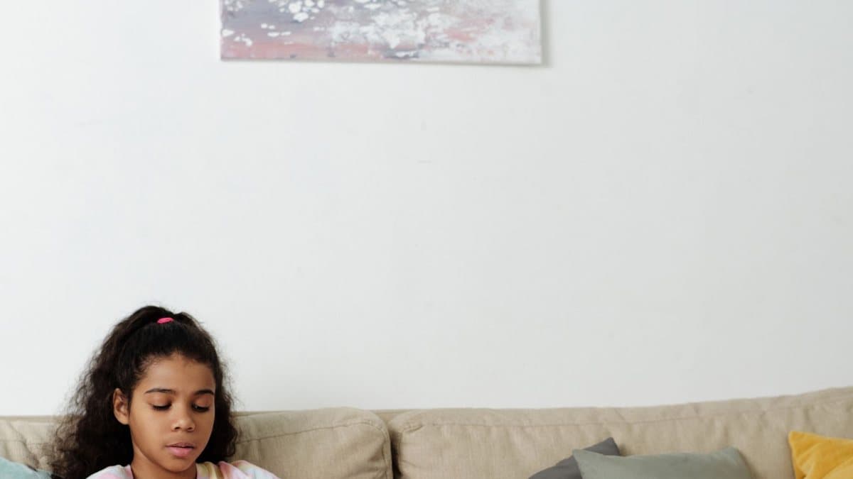 Person using a tablet on a sofa, representing evolving streaming technology trends