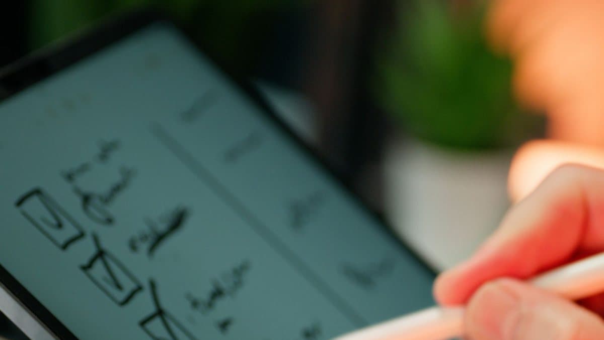 Hands completing a digital checklist, representing the requirements for a good 4K streaming setup