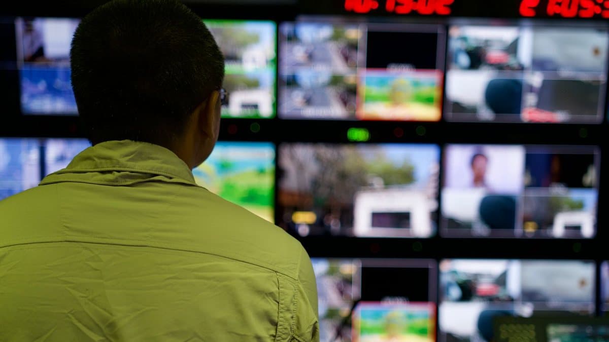 Person comparing multiple screens, representing differences between streaming services