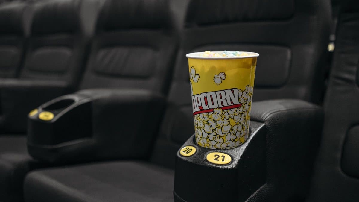 Cinema-style seating with popcorn, representing comparing entertainment options
