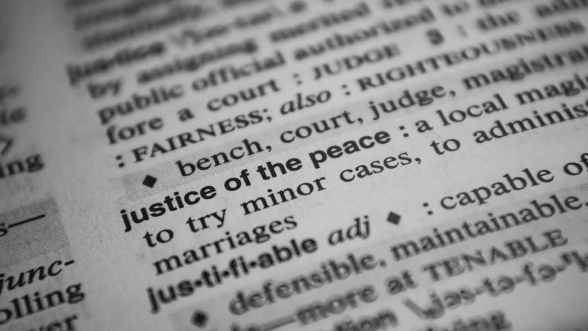 Close-up of dictionary text, representing clarifying two similar but distinct terms